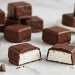 Cool Whip candy squares with chocolate coating showing fluffy white interior